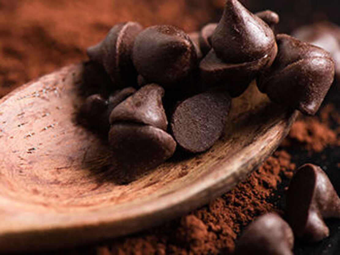 Cocoa powder and spoon with chocolate drops